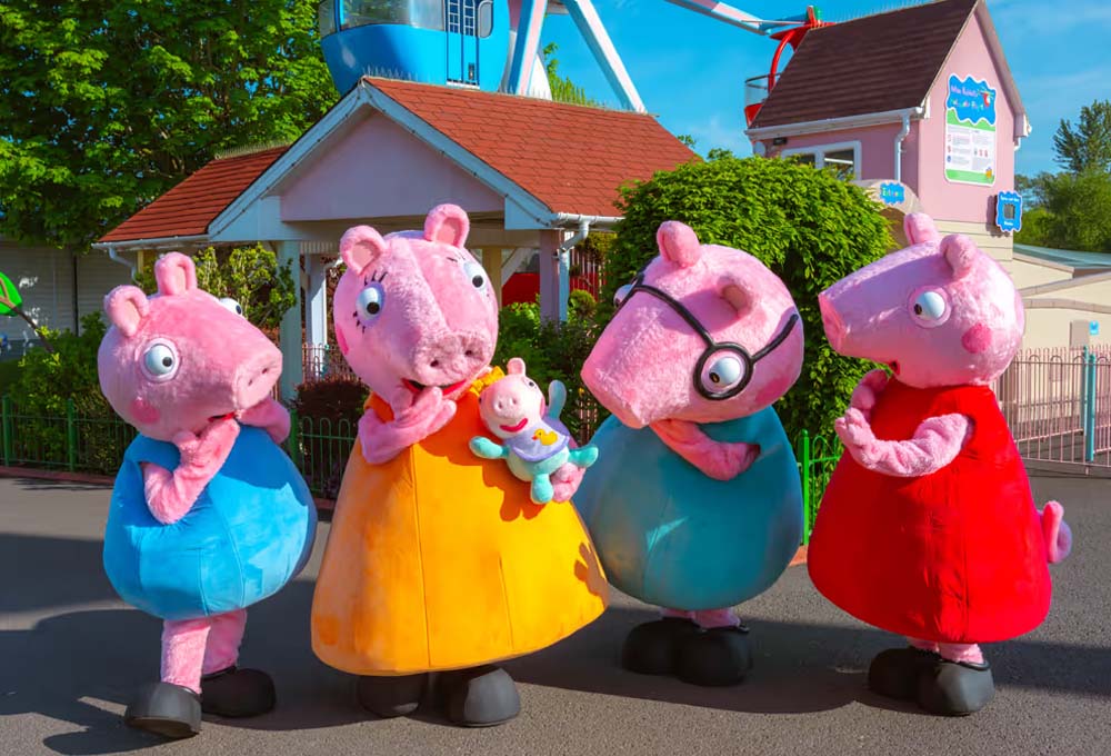 Peppa Pig, George Pig, Mummy Pig, Daddy Pig and Evie Pig meeting guests in Peppa Pig World at Paultons Park