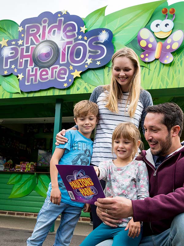Family collecting their ride photos at the Photo Pass kiosk in Paultons Park
