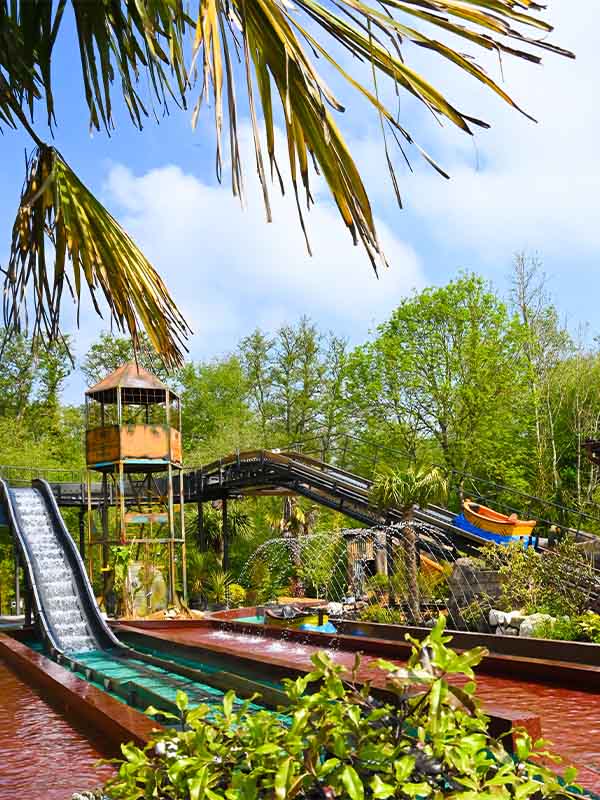 Splash Lagoon log flume track and viewing tower surrounded by lush greenery at Paultons Park