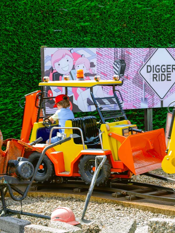 Children riding mini construction vehicles around the Digger Ride track at Paultons Park