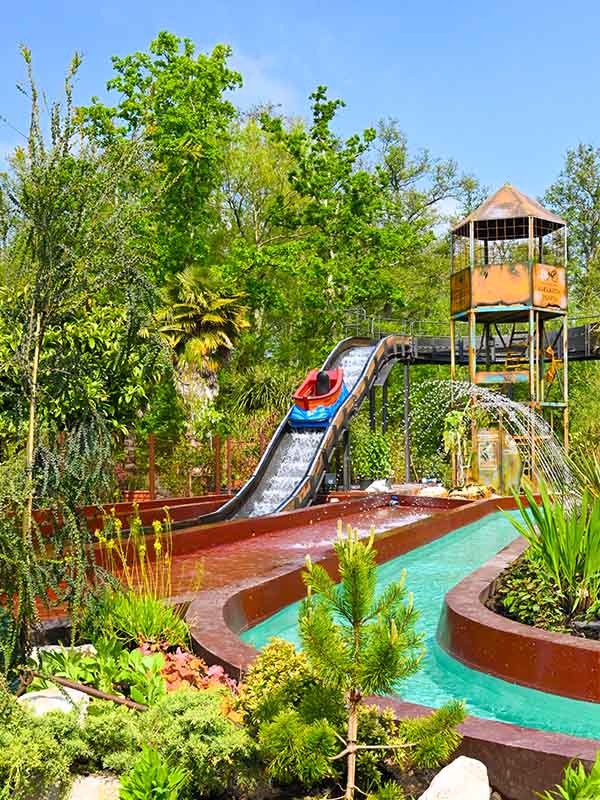 Splash Lagoon water ride at Paultons Park with boat descending drop into tropical themed lagoon