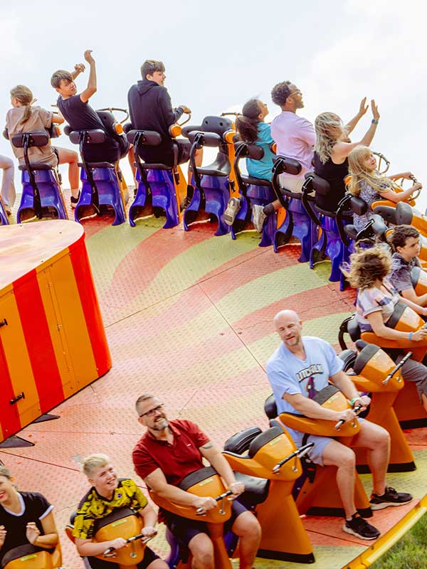 Thrill seekers raising their hands on EDGE at Paultons Park as the ride swings upward