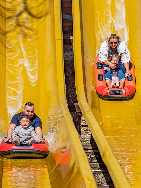 Parent and child enjoying a splashdown on Buffalo Falls at Paultons Park