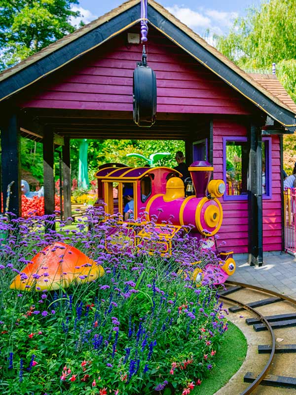Professor Blast’s Expedition Express train arriving at the themed station building at Paultons Park