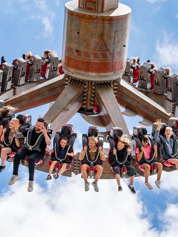 Riders inverted on Cyclonator at Paultons Park experiencing high-speed spinning excitement