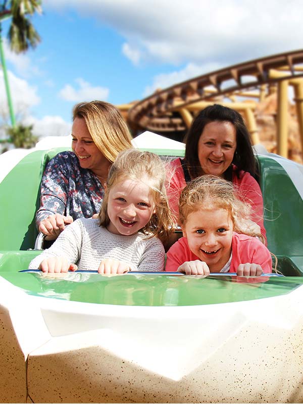 Family enjoying Boulderdash ride in dinosaur egg themed cars at Paultons Park