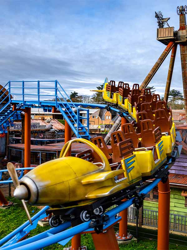 Farmyard Flyer roller coaster train at Paultons Park with plane themed cars climbing track