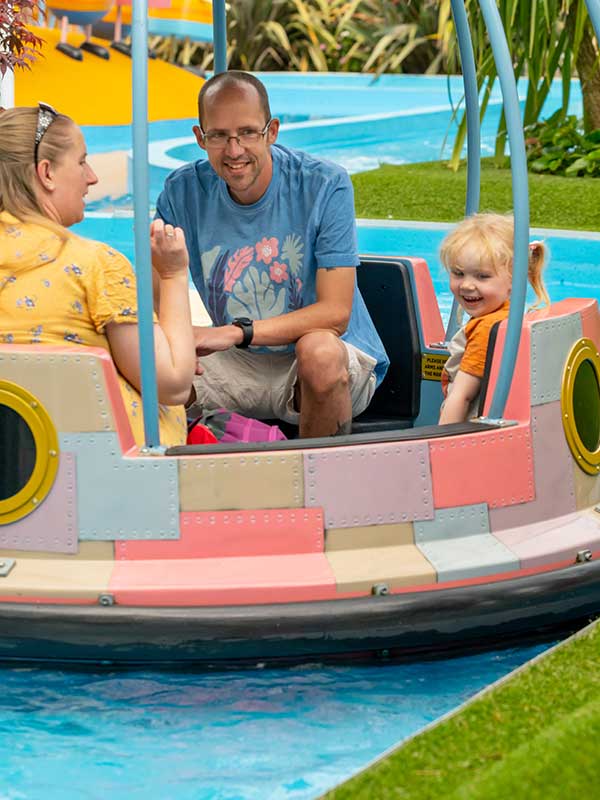 Family enjoying Grampy Rabbit’s Sailing Club boat ride in Peppa Pig World at Paultons Park