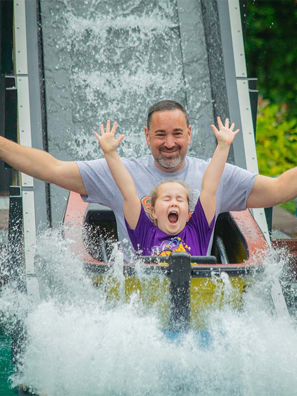 Child and parent laughing on Splash Lagoon water ride at Paultons Park