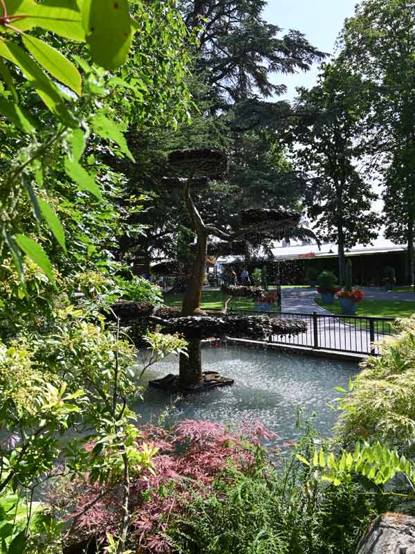 Water fountain and sculpted trees in the Japanese Garden at Paultons Park