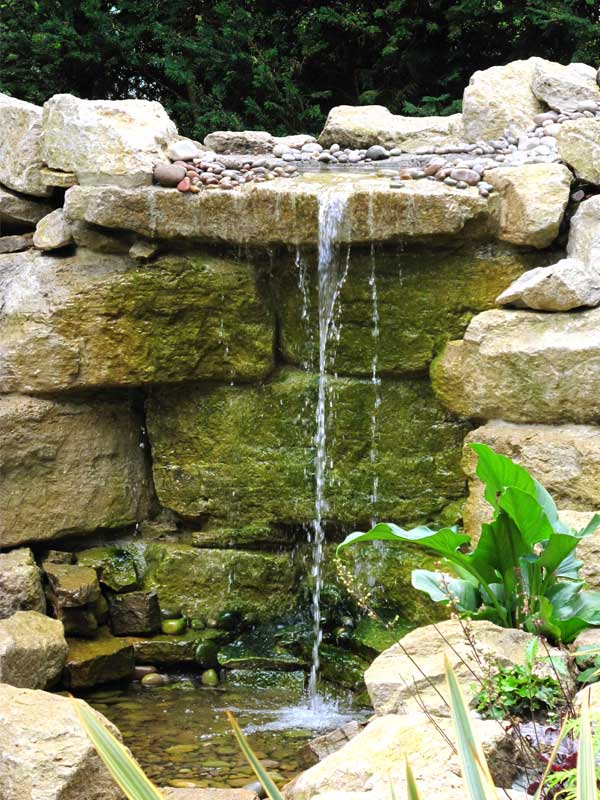 Rock waterfall and tropical planting in Jungle Falls Garden at Paultons Park