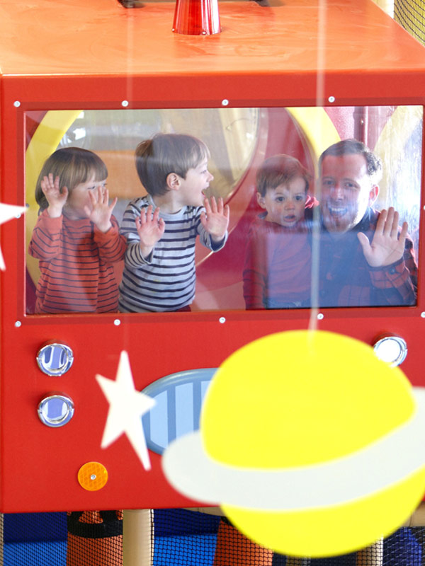 Children and parent inside spaceship themed play structure at George's Spaceship Indoor Playzone in Peppa Pig World