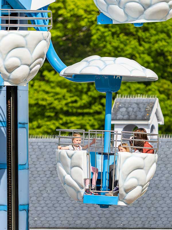 Children enjoying Windy Castle Ride in cloud gondola at Peppa Pig World in Paultons Park