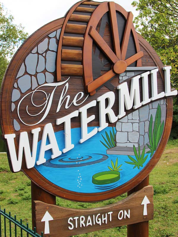 Traditional red watermill machinery inside The Watermill at Paultons Park