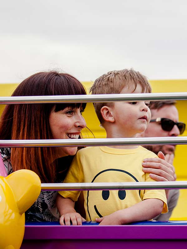Mother and child smiling on The Queen’s Flying Coach Ride in Peppa Pig World at Paultons Park