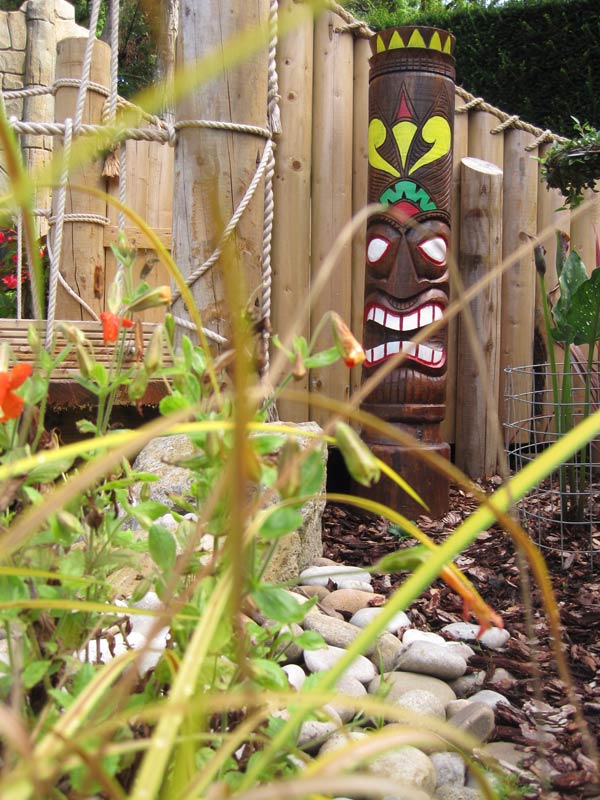 Landscaped walkway and picnic area in African Gardens at Paultons Park with rope fencing and tropical planting