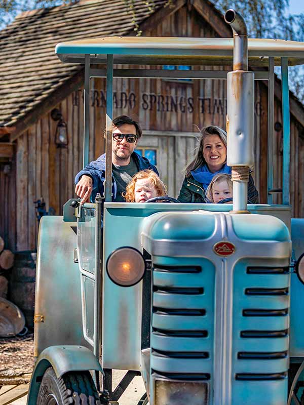 Family enjoying the Trekking Tractors ride at Paultons Park in a vintage style tractor vehicle