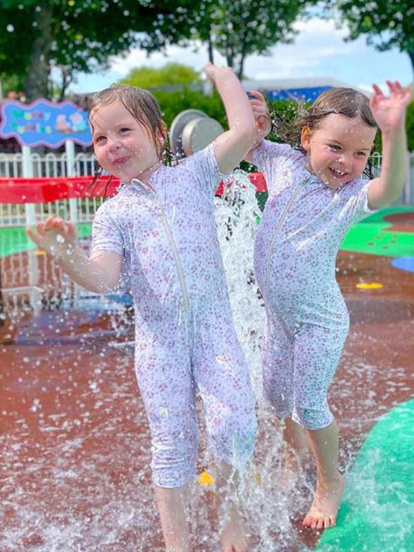 Children playing in water jets at Muddy Puddles Water Splash Park in Peppa Pig World at Paultons Park