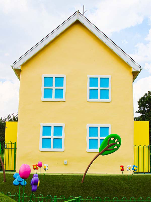 Mummy Pig and George inside Peppa Pig’s House dining room at Peppa Pig World Paultons Park