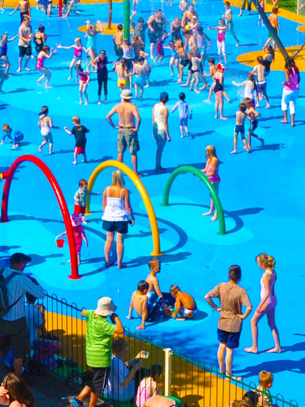 Families enjoying splash pad fountains at Water Kingdom Splash Park at Paultons Park
