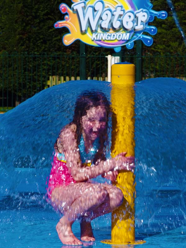 Child playing under water dome fountain at Water Kingdom Splash Park at Paultons Park