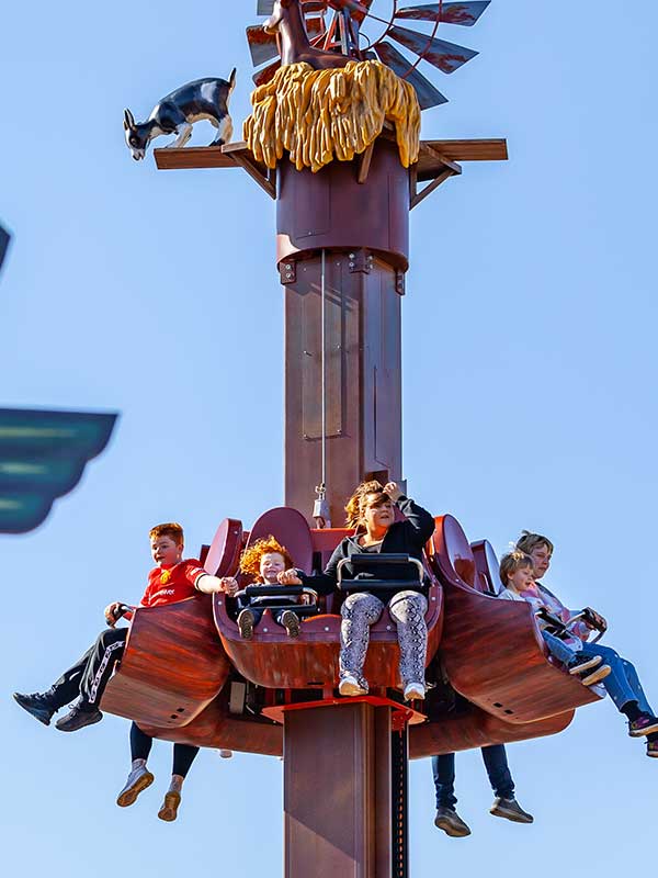 Family seated on Windmill Towers at Paultons Park during gentle drop sequence