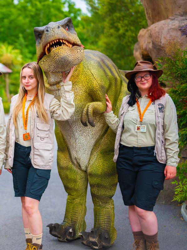 Park rangers posing with dinosaur at Alive! Dinosaur Encounter in Lost Kingdom at Paultons Park