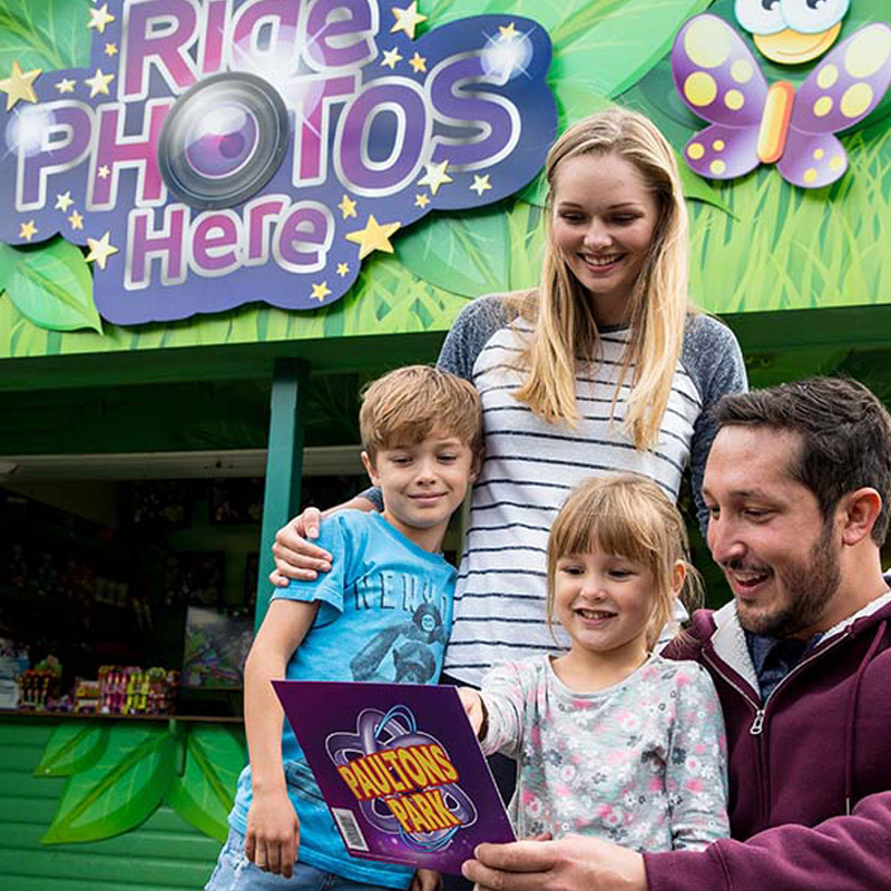 Family viewing their ride photos at Paultons Park Photo Pass kiosk