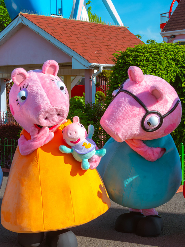 Peppa Pig and Daddy Pig meeting guests in Peppa Pig World at Paultons Park