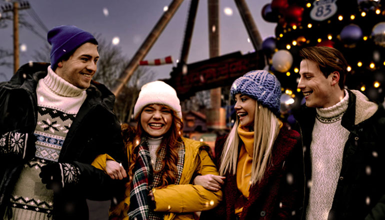 Friends enjoying festive lights and attractions during Festive Party Nights at Paultons Park