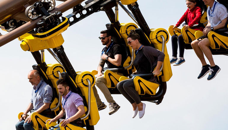 Colleagues enjoying a suspended rollercoaster ride during a company away day at Paultons Park