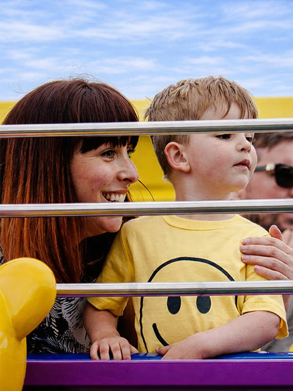 Mother and child smiling on The Queen’s Flying Coach Ride in Peppa Pig World at Paultons Park