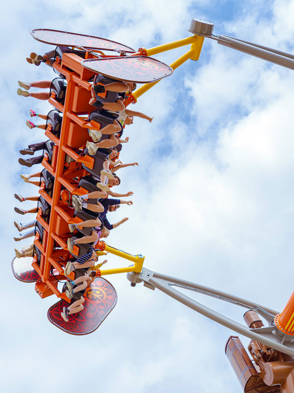 Riders on Vild Swing at Paultons Park soaring against the sky on the Viking themed attraction.
