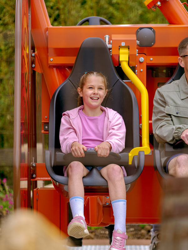 Young rider smiling on Vild Swing at Paultons Park during a family ride experience.