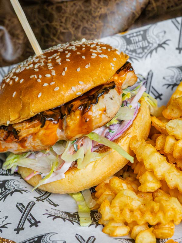 Chicken burger with coleslaw and crinkle-cut fries served at Feasting Hall in Valgard at Paultons Park.