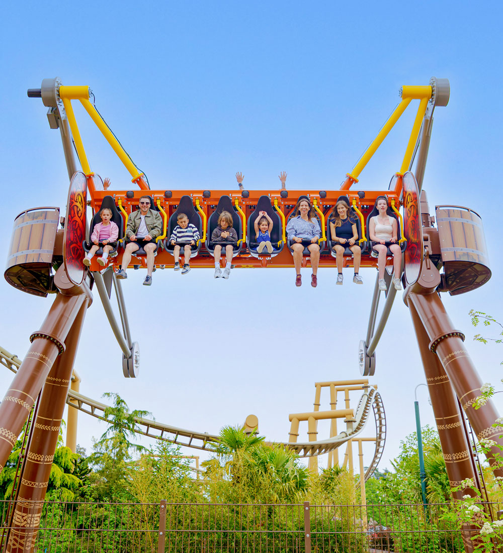 Guests ride Vild Swing in Valgard at Paultons Park, seated high above the ground on the Viking-themed family thrill ride.
