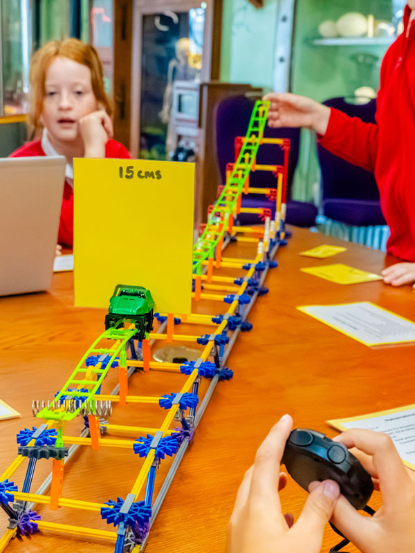 Children testing a model ride during the Air Resistance Challenge Workshop at Paultons Park.