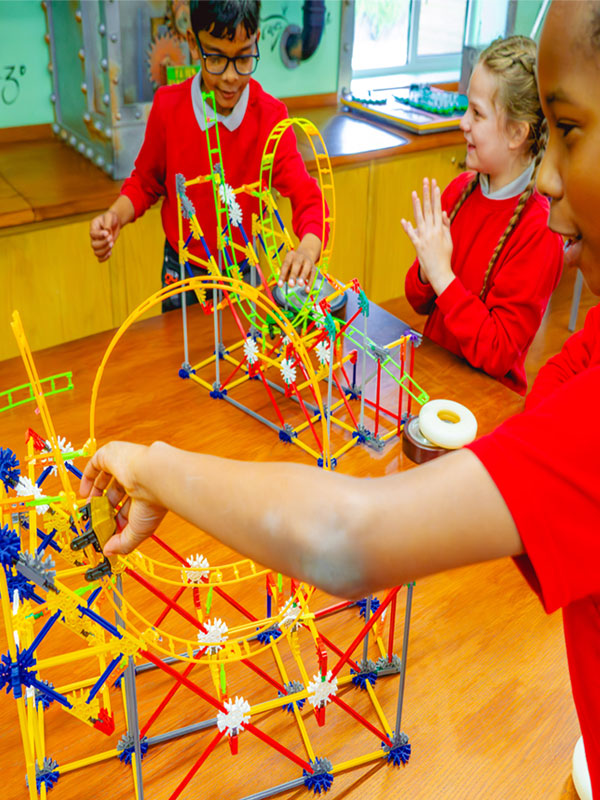Children building and testing model rollercoasters during a Rollercoaster Forces workshop at Paultons Park.