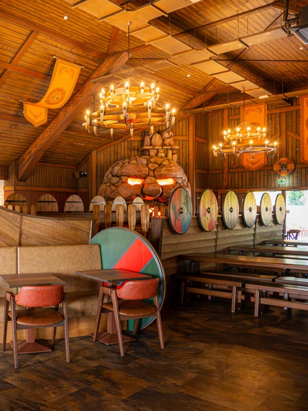 Paultons Park Valgard Feasting Hall interior with Viking shields, wooden booths and themed dining area