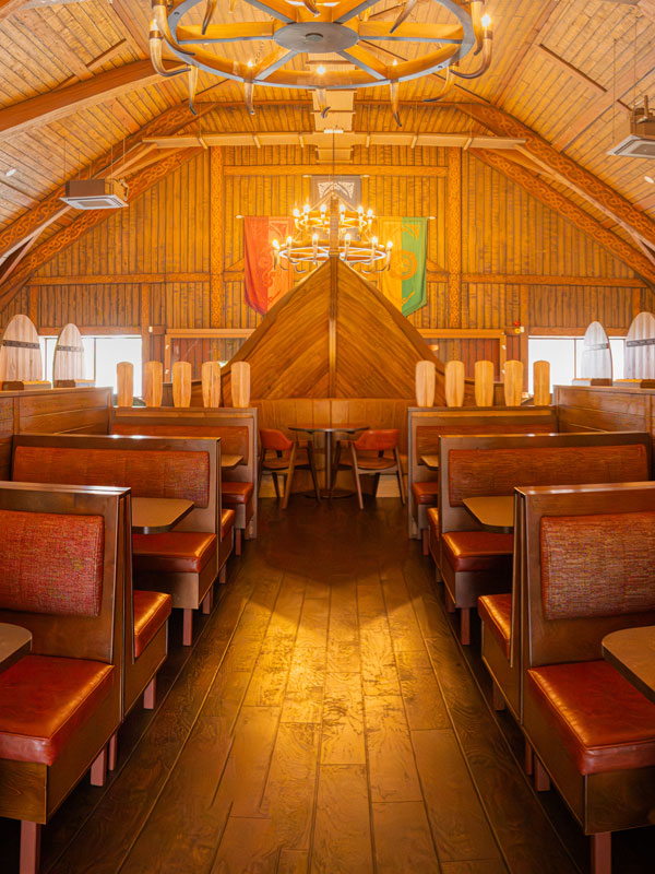 Paultons Park Valgard Feasting Hall interior with wooden booth seating and Viking-themed decor