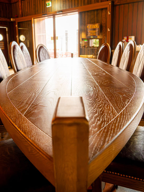 Paultons Park Valgard Feasting Hall wooden Viking boat table in the themed restaurant interior Gallery 6	paultons-park-valgard-feasting-hall-viking-interior-gallery-6.jpg	Paultons Park Valgard Feasting Hall interior with wooden booth seating and Viking-th