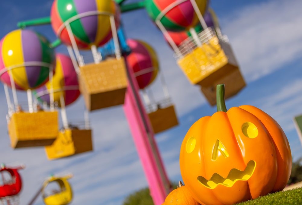 Peppa Pig World at Halloween with a pumpkin decoration in front of Peppa's Big Balloon Ride